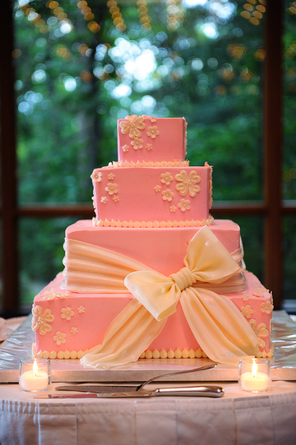 Coral four layer wedding cake with yellow bow - photo by Kenny Nakai Photography